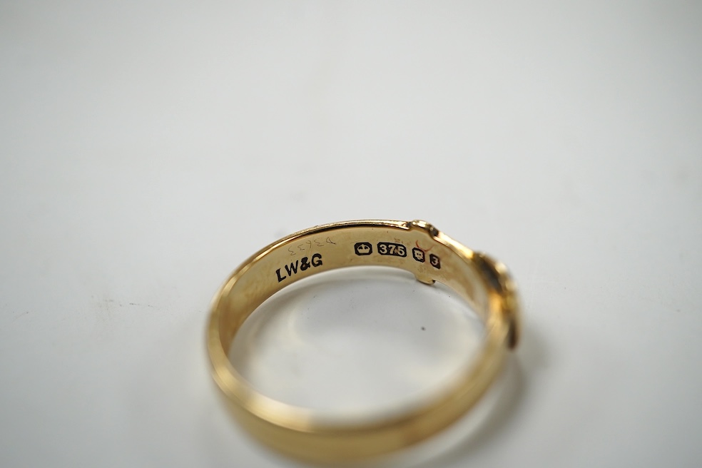 A modern 9ct gold buckle ring, 2.2 grams and a 22ct gold wedding band, 1.6 grams. Condition - poor